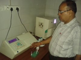 Dr. Raj Kumar Singh checking patient reports at Garhwal Homeopathic Clinic near Church Road Kotdwar